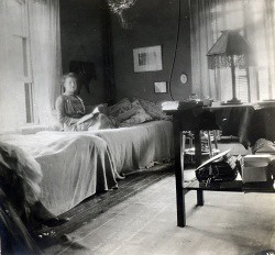 A student in her newly electrified room in Main Building, circa 1912.